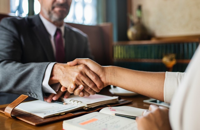Homebuyer and Lender Shaking Hands in a Meeting